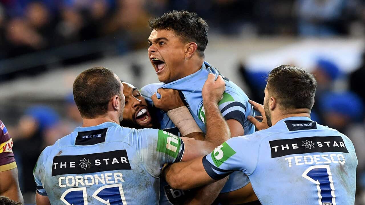 Latrell Mitchell of the Blues celebrates after he scores a try during Game 1 of the 2018 State of Origin series at the MCG in Melbourne