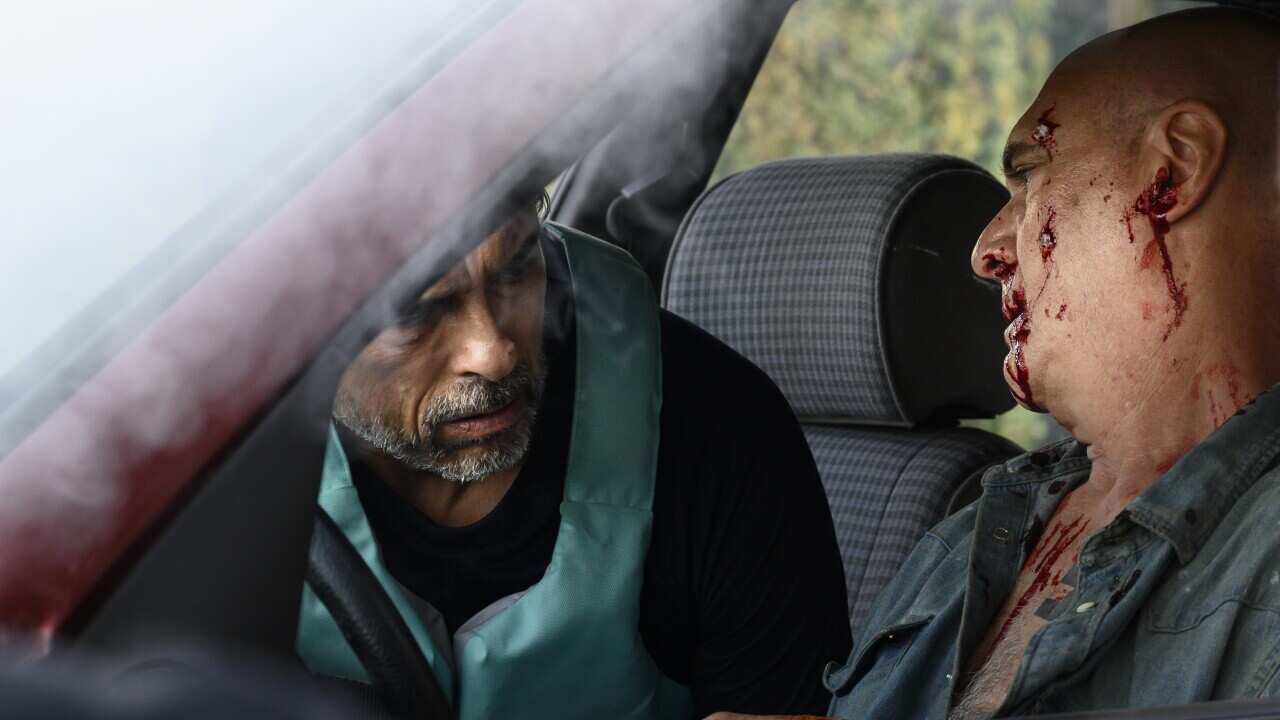 Two men in a car, one is bleeding, a scene from the movie Thou Shalt Not Hate