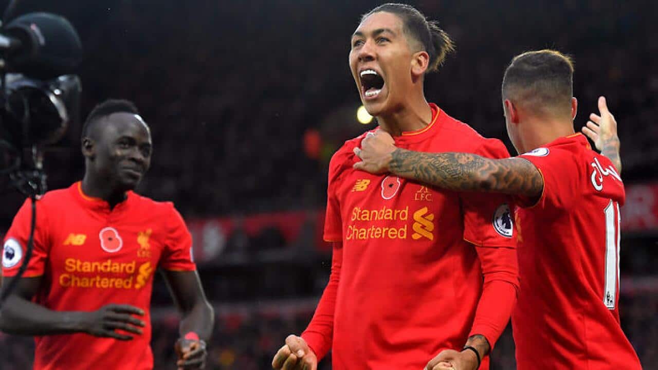 Roberto Firmino, centre, celebrates after netting Liverpool's fourth