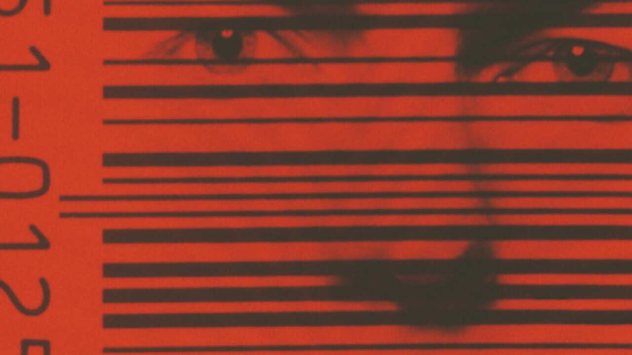 A human face behind the black bars of a barcode, 1982.