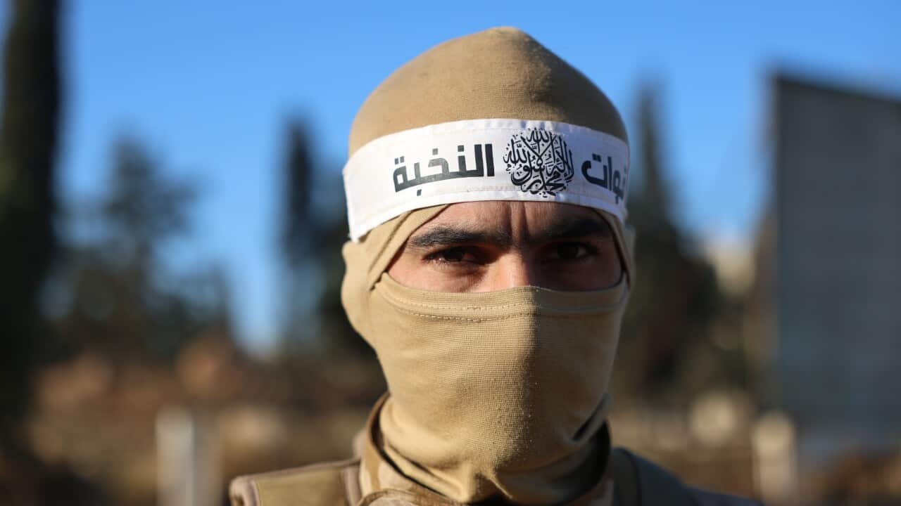 An opposition fighter patrols on a street in Aleppo, Syria, 30 November 2024,