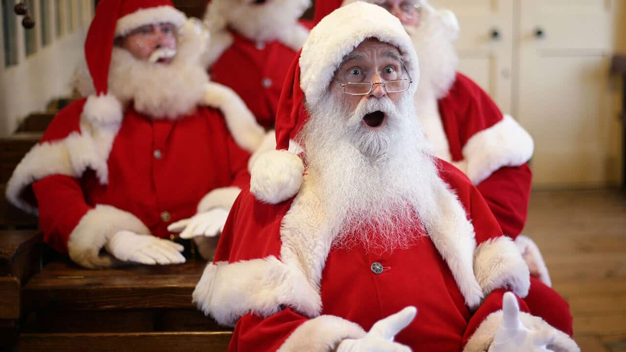 Father Christmas performers receiving instruction in a classroom, during a photo call for the Ministry of Fun Santa School.