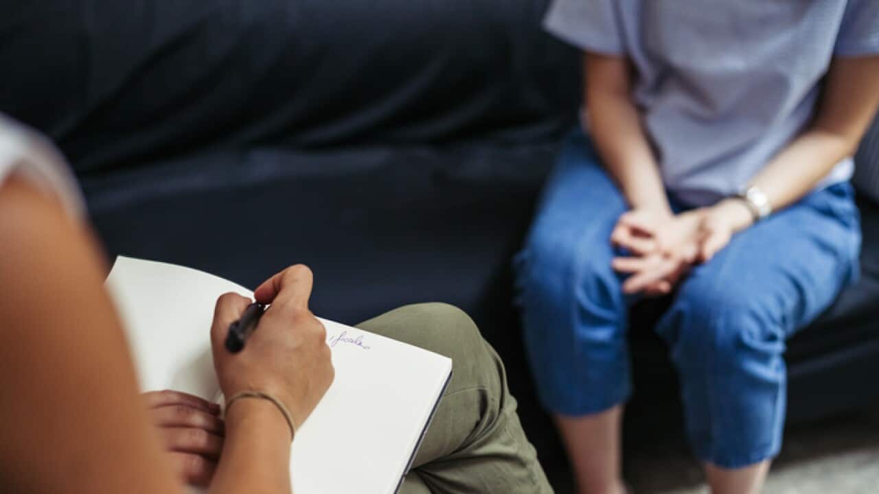 Psychotherapy session, woman talking to his psychologist in the studio