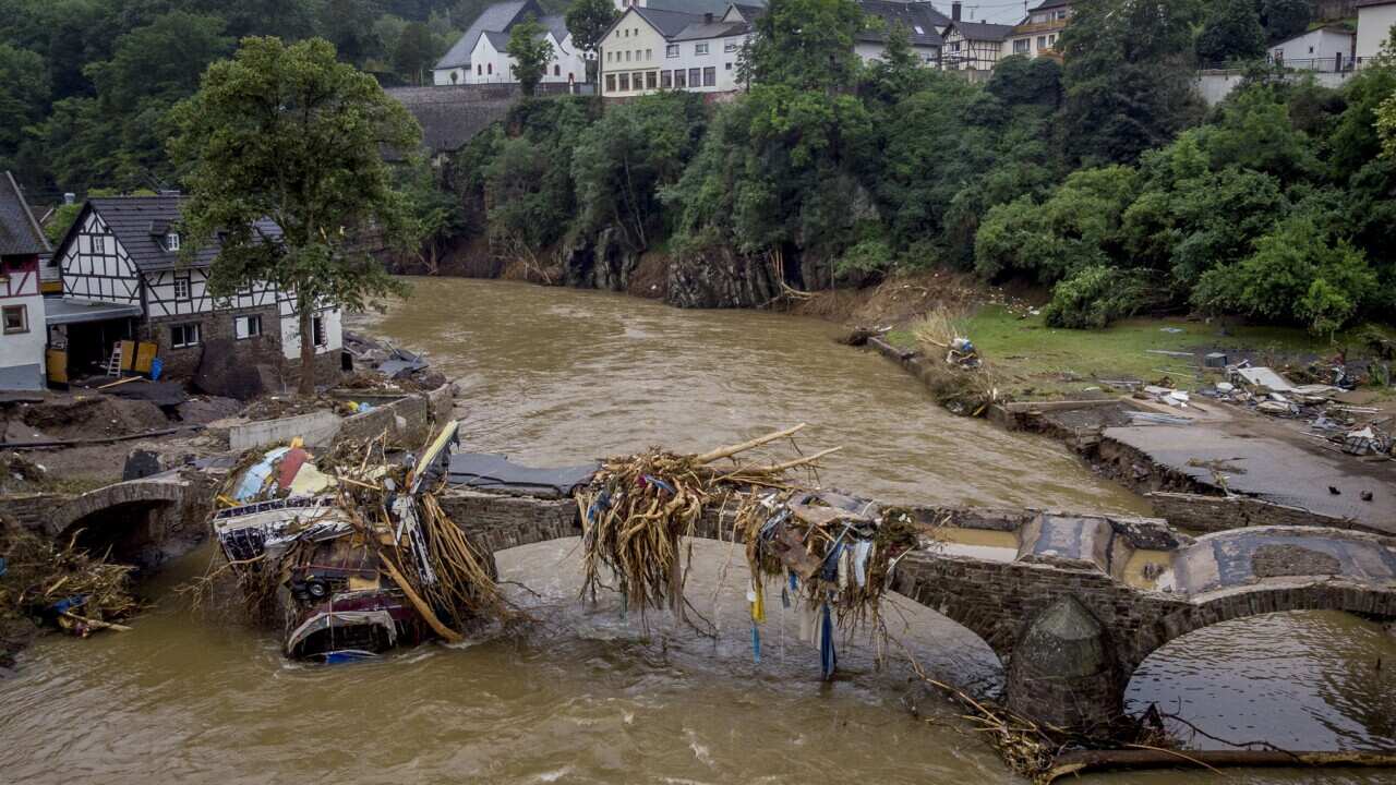 Debris hangs on a damaged bridge after the July floods in Schuld