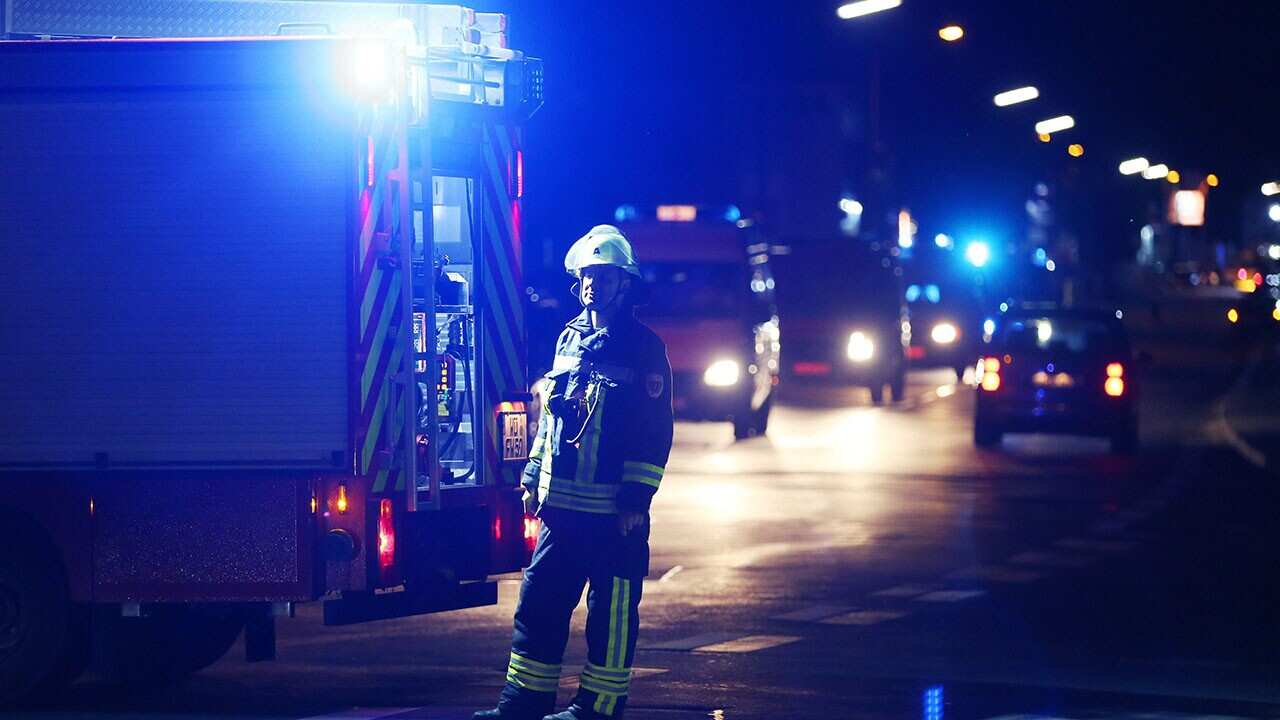 firefighter stands at a road block in Wuerzburg