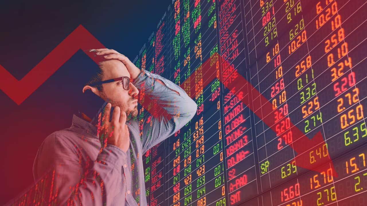 A red arrow super imposed on an image of a man and a screen with red letters and numbers