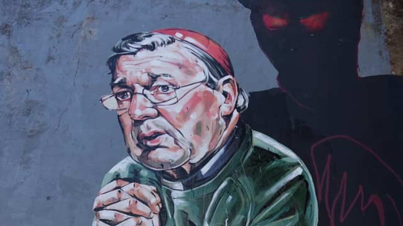 A mural of George Pell praying in front of a demonic figure has been removed from a car park in Sydney.
