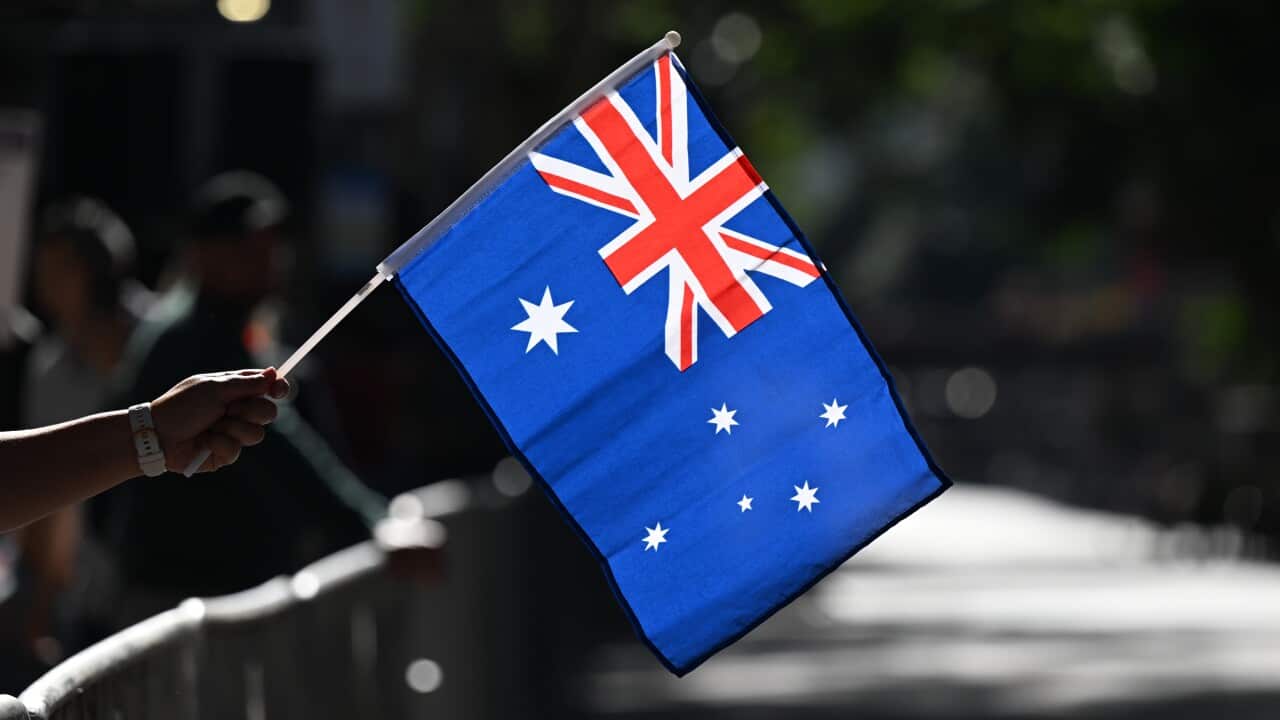 An Australian flag being held in a hand