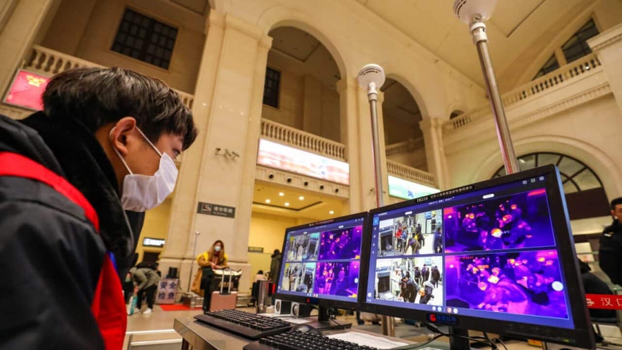 A worker monitors screens for fever signs on passengers detected by infrared detectors at Hankou Railway Station in Wuhan