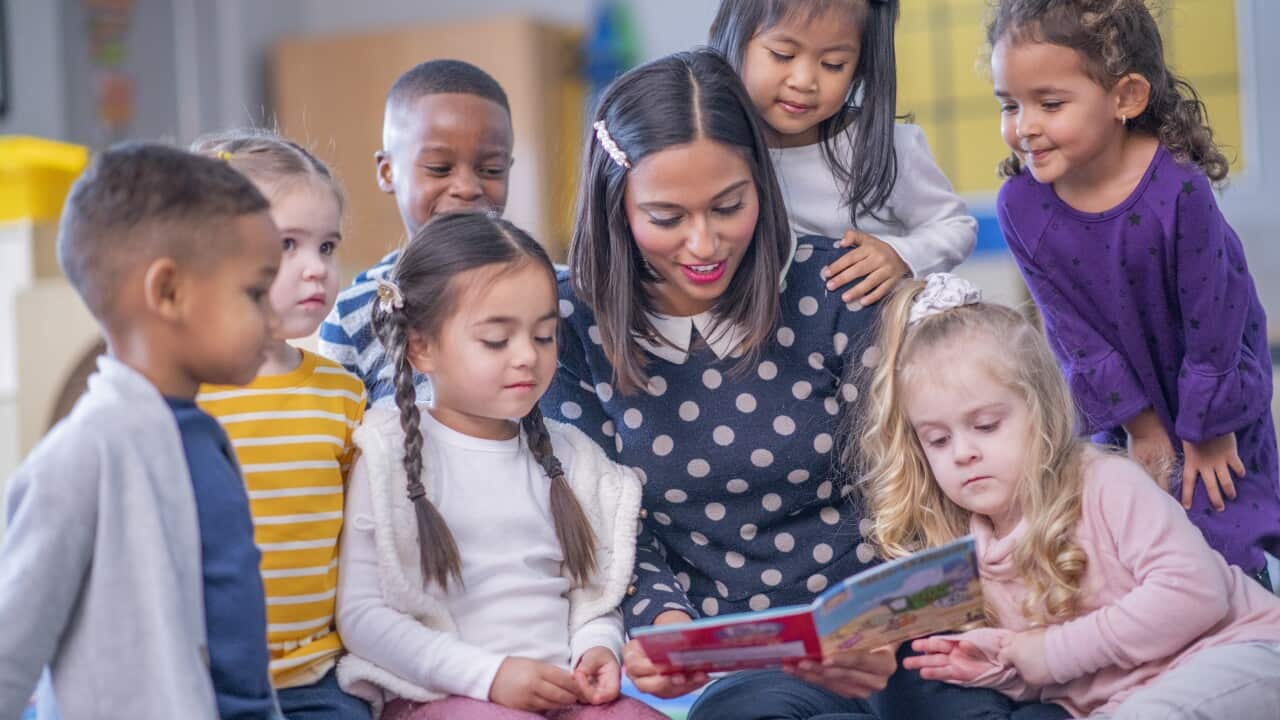 Teacher Reading to Daycare Children stock photo