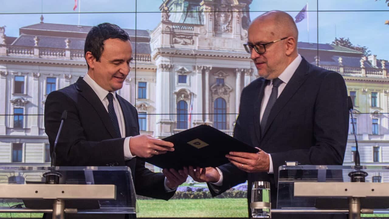 Kosovo Prime Minister Albin Kurti (L) holds an application to join the EU with Czech minister Mikulas Bek (R) (AAP)