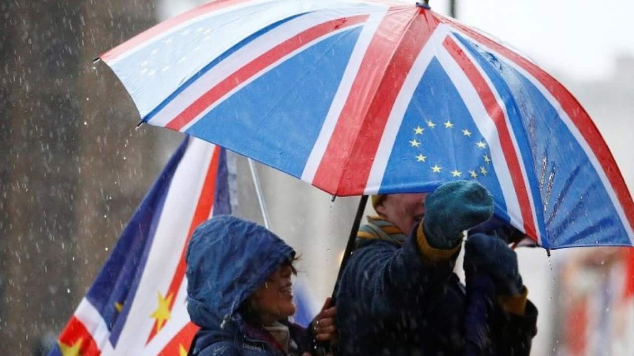 Anti-Brexit protesters shelter from the rain outside the Houses of Parliament, after Prime Minister Theresa May's Brexit deal was rejected, in London, Britain, Jan 16, 2019.