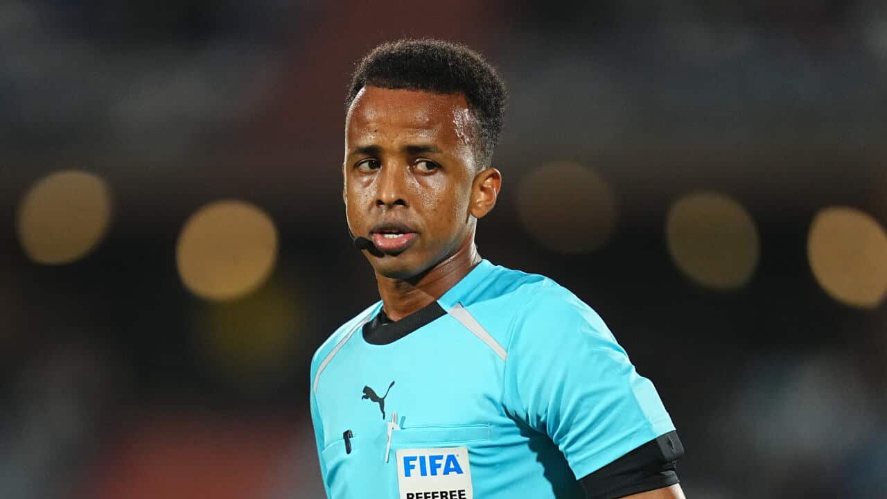 Somali referee Omar Artan wearing a FIFA referee uniform during a football match.