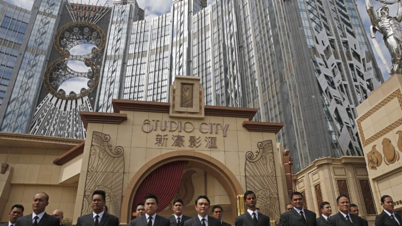 Security guards stand outside the Melco Crown Studio City in Macau