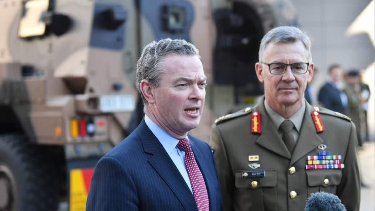 Christopher Pyne (l) and Lieutenant General Rick Burr speak to media.