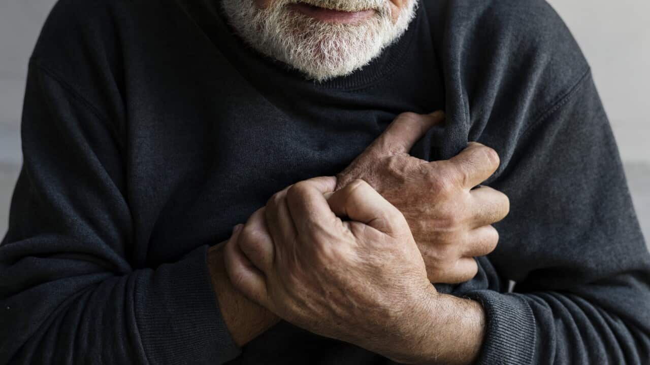Closeup of elderly man having heart attack chest pain