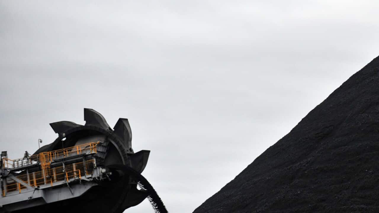 A loader shifts coal