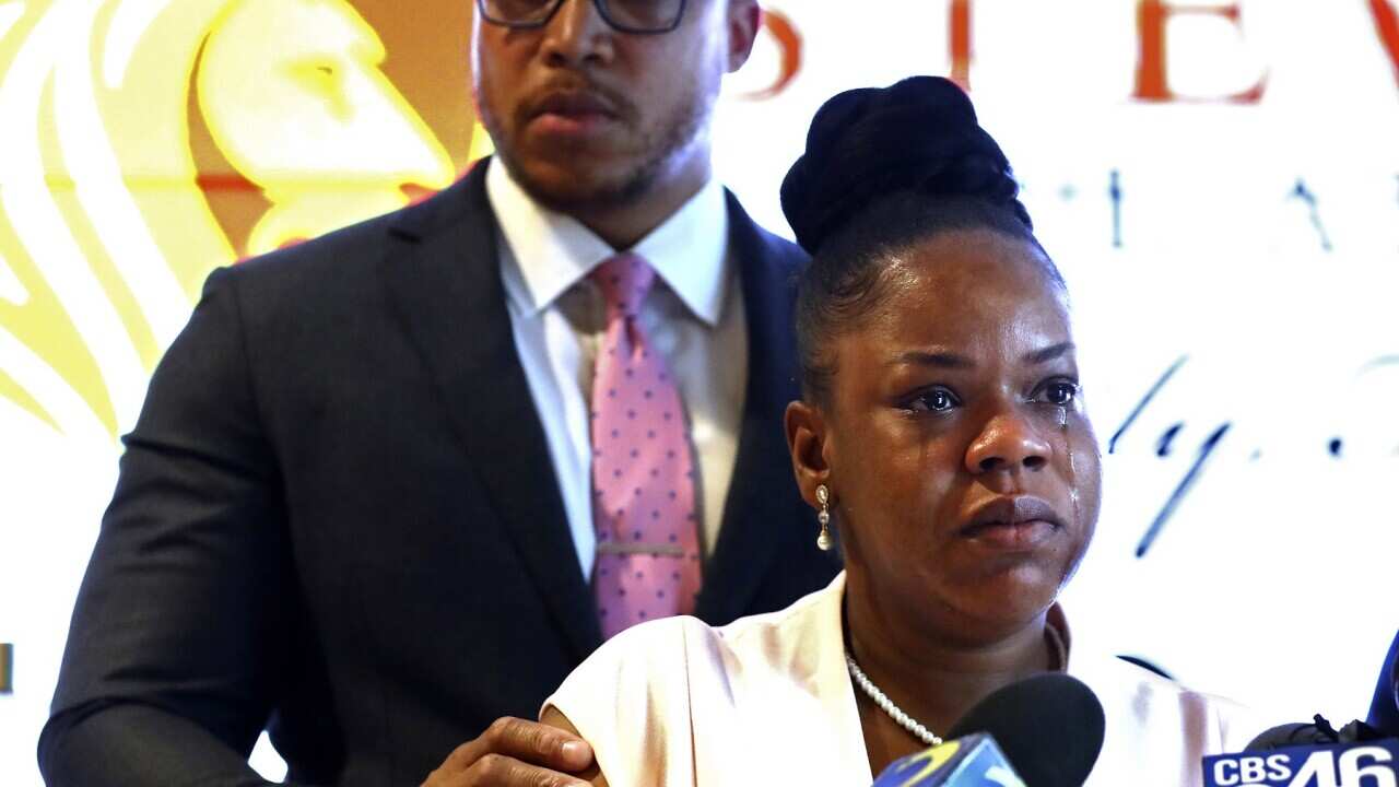 Tomika Miller, widow of Rayshard Brooks cries during a news conference