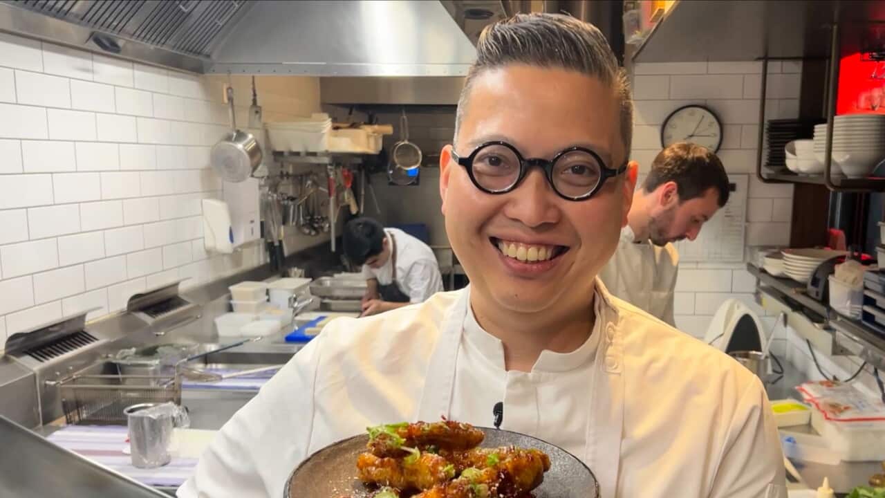 Restaurateur Victor Liong holding a dish of honey chicken.