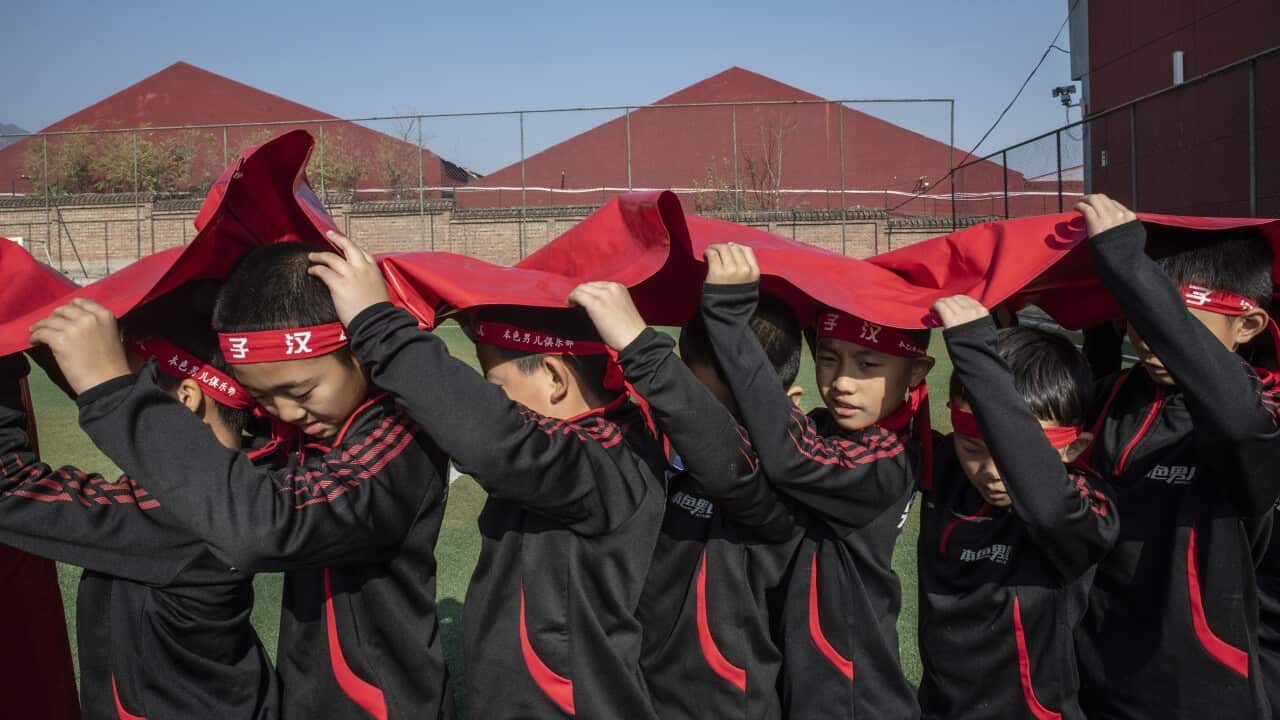 Boys enrolled at the Real Boys Club take part in an exercise aimed at teaching them about collective effort, in Beijing.