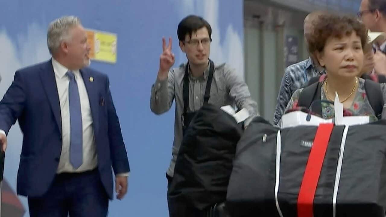 Australian student Alek Sigley arrives at the airport in Beijing