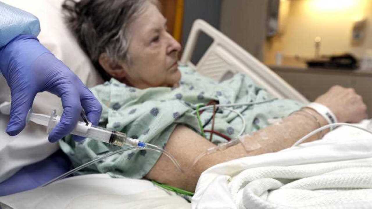 A nurse administers an IV to a patient