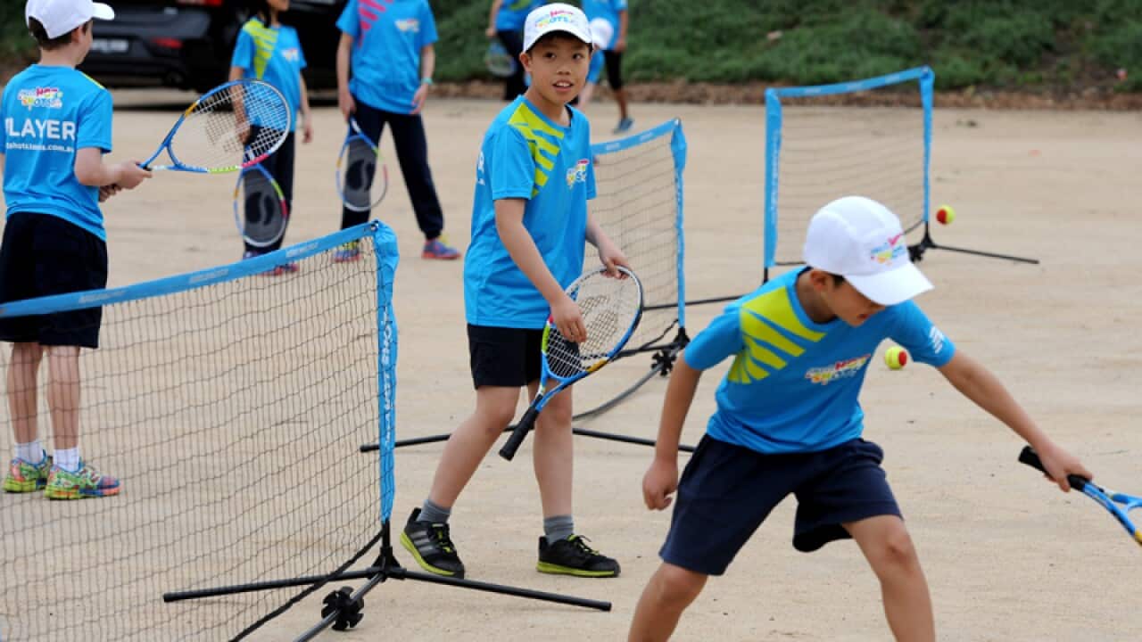 Children participate in a tennis program