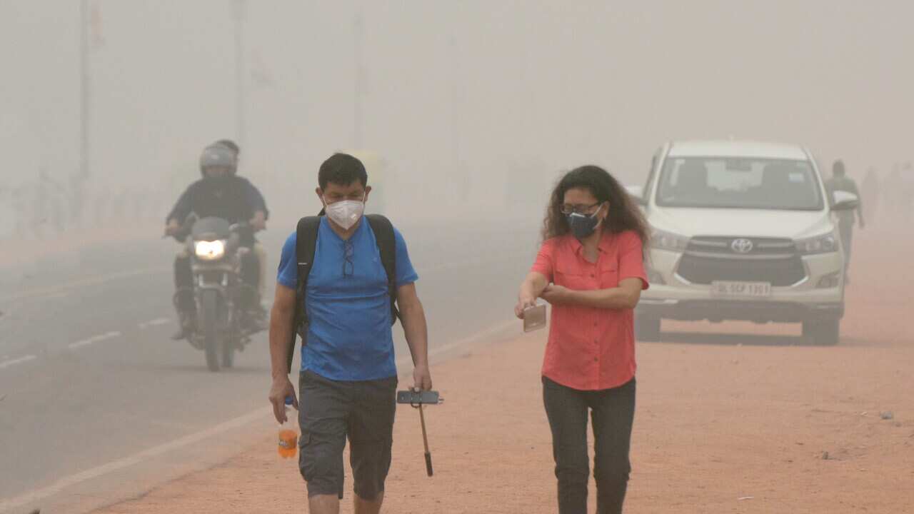 Pollution Maintains Tourists seen wearing mask to protect themselves from smog, at Rajpath, on November 3, 2019 in New Delhi, India.On Delhi-NCR As Air Quality Breaches Index In Some Areas