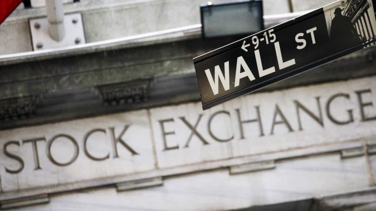 Photo shows a Wall Street street sign outside the New York Stock Exchange in New York.