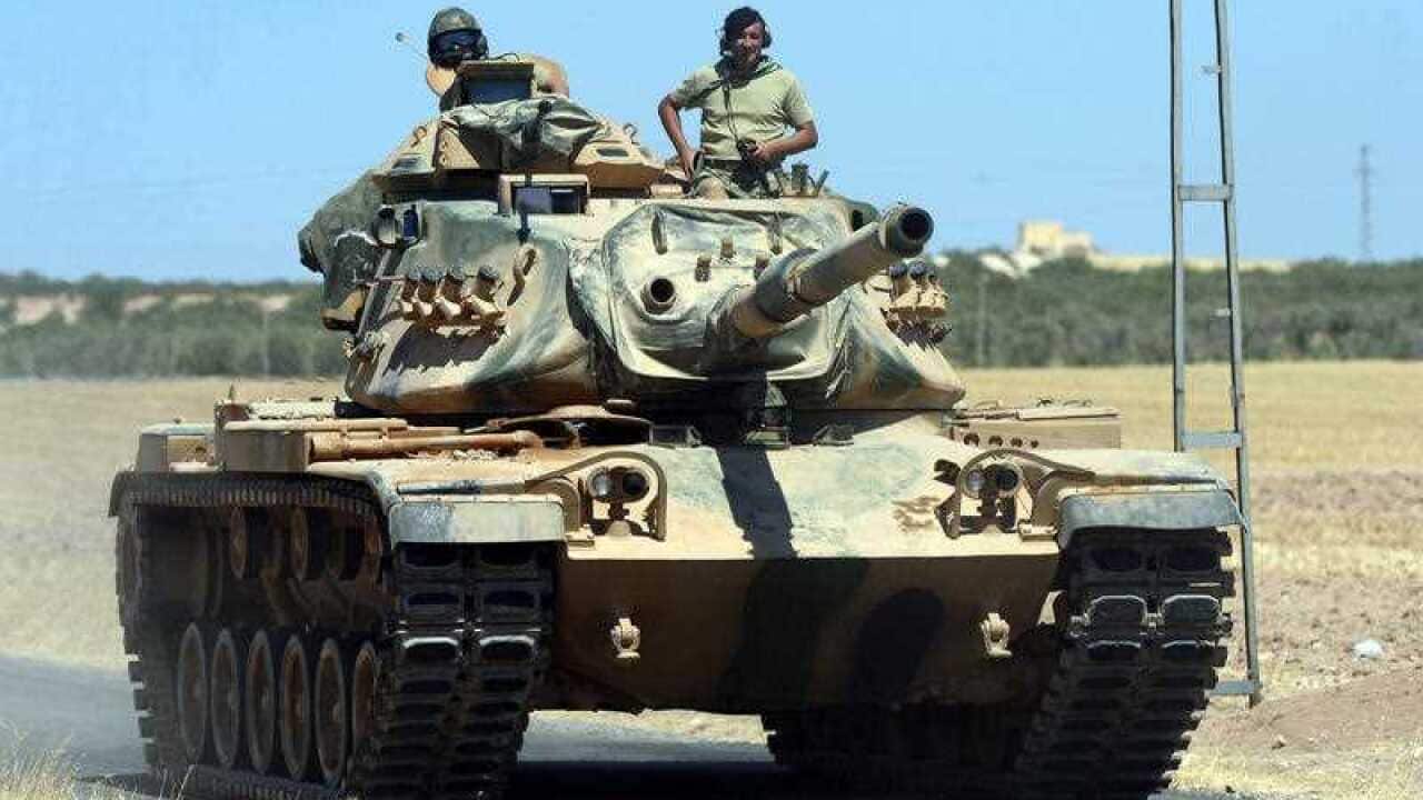 A Turkish tank heads to the Syrian border, in Karkamis, Turkey.