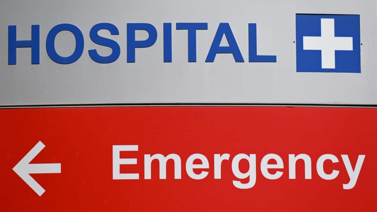 A hospital sign pointing the way to the emergency room. The word hospital appears at the top of the sign in white and blue. Below that, the word Emergency appears in red and white, with an arrow pointing the viewer to the left.