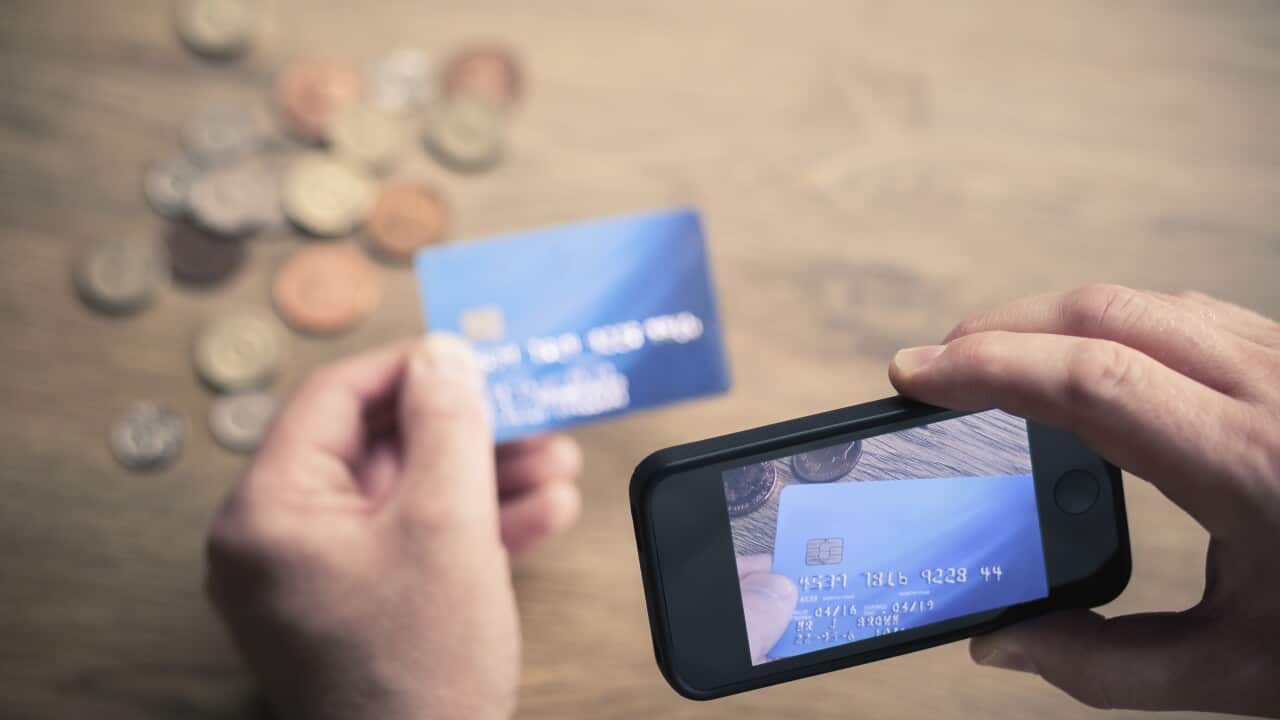 Mans hands photographing credit card