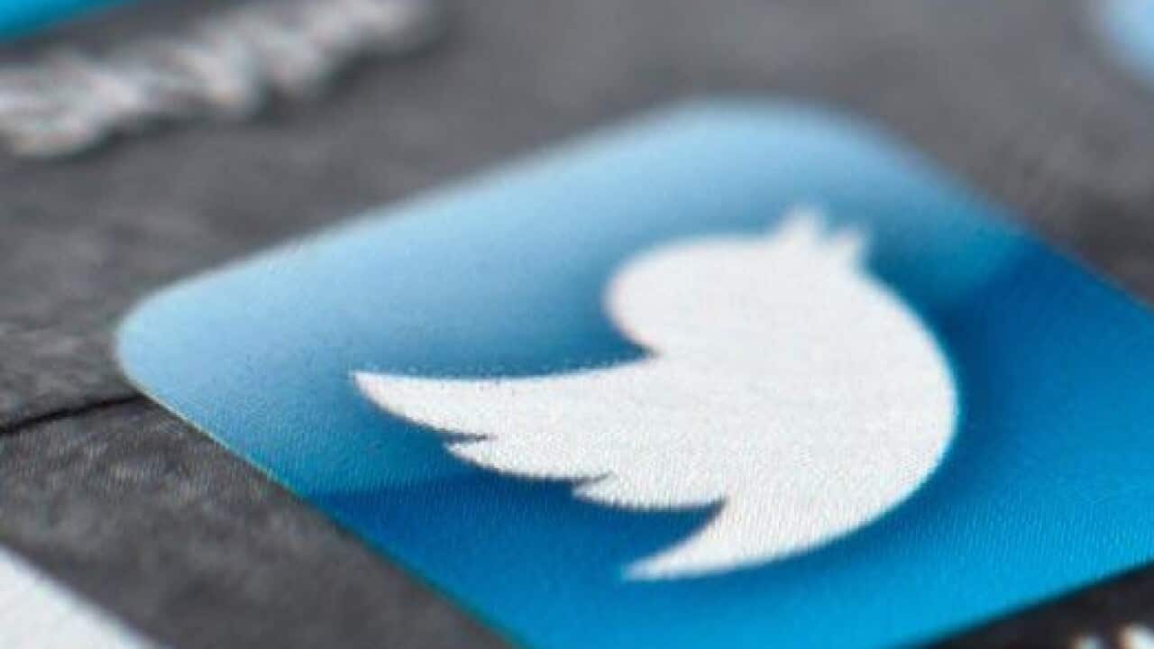 A smartphone display shows the Twitter logo