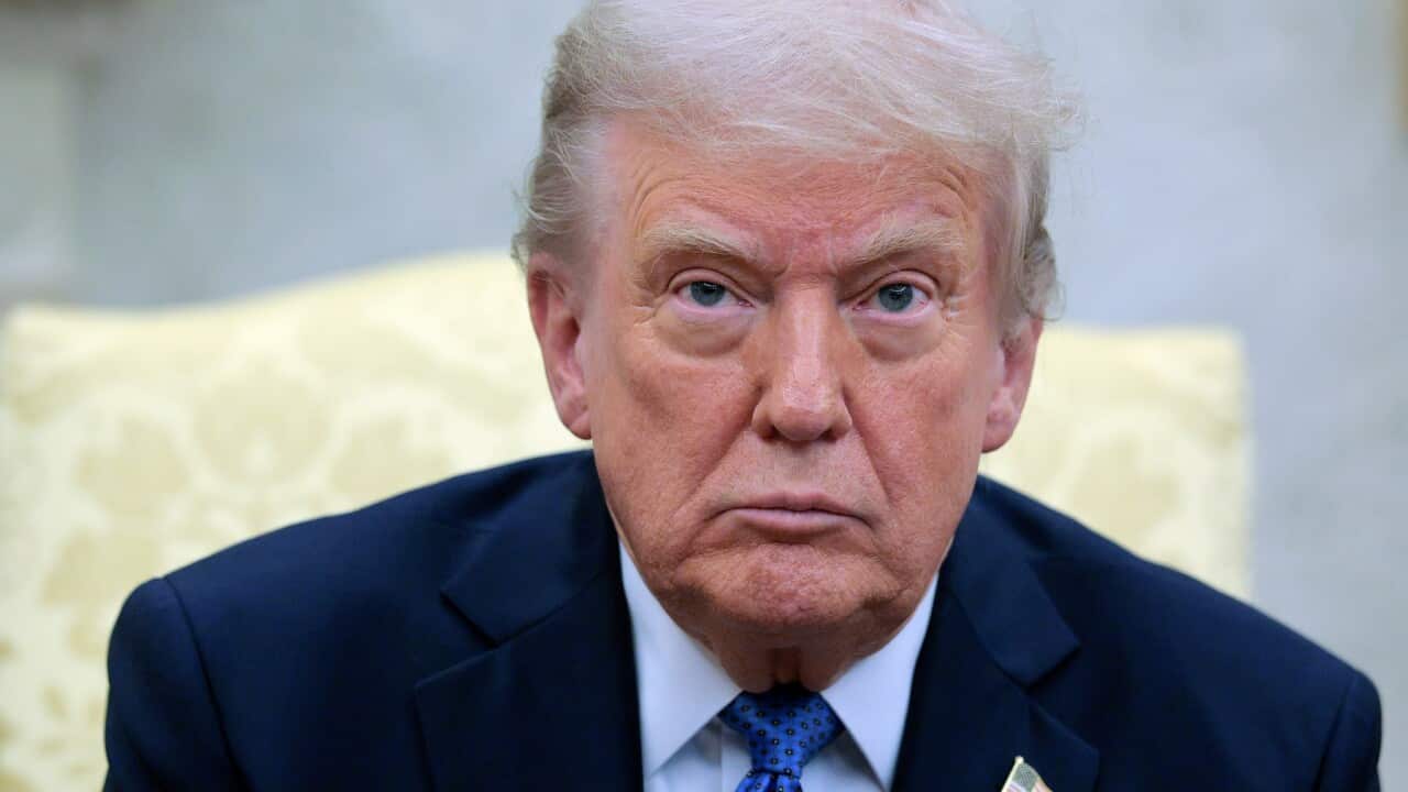 Donald Trump in a blue suit and a matching tie.