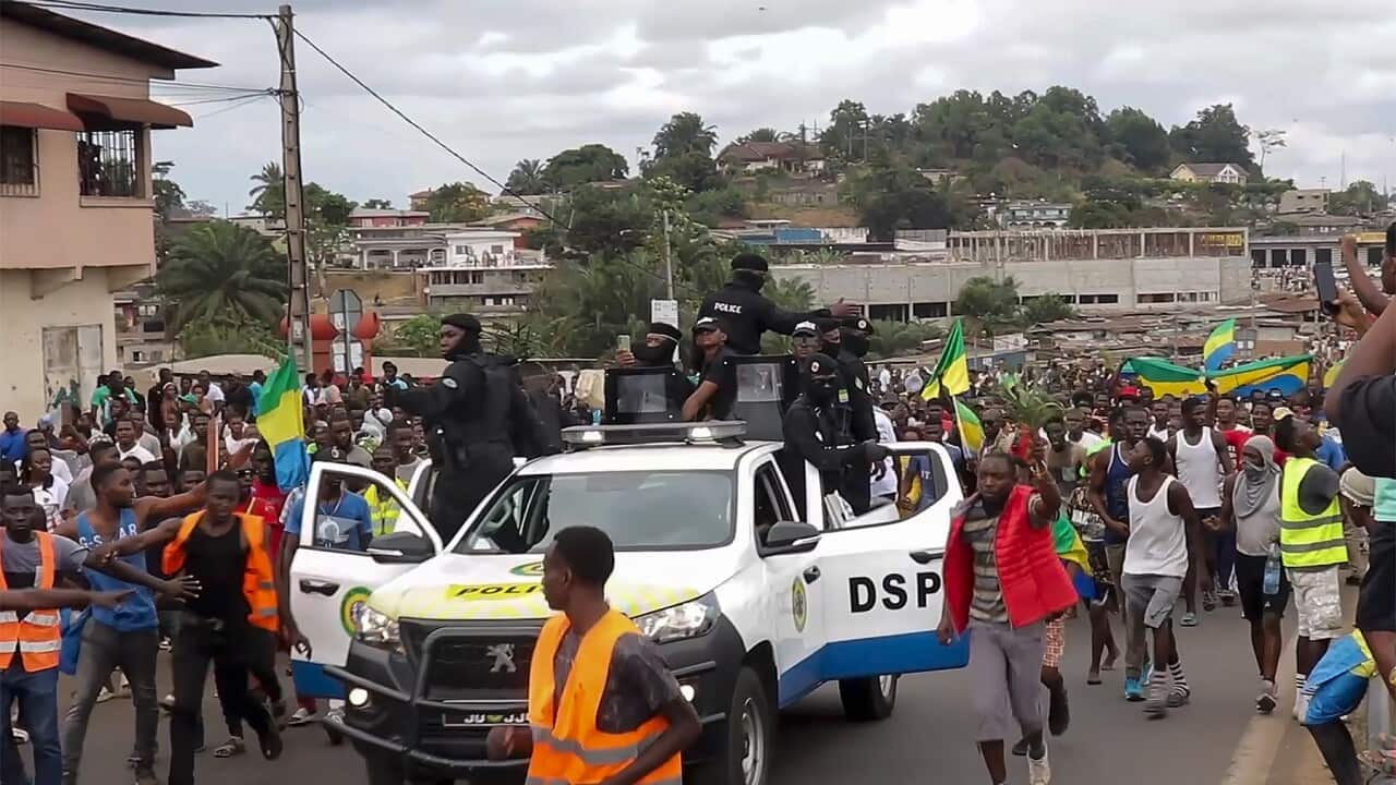 Coup supporters cheering police officers in Libreville, Gabon (AAP)