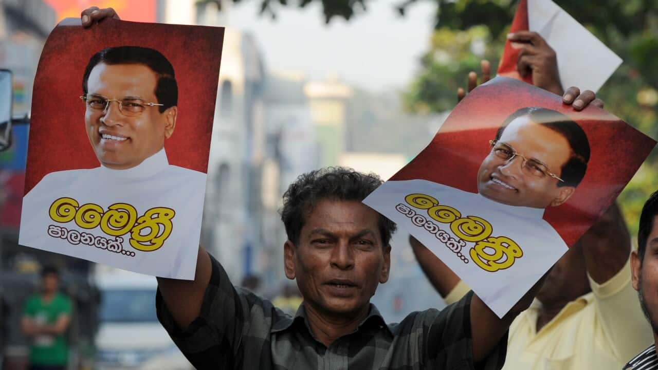 A supporter of Sri Lanka's newly elected president Maithripala Sirisena holds up his poster during celebrations after Sri Lanka's President Mahinda Rajapakse conceded defeat. (AFP/Getty)