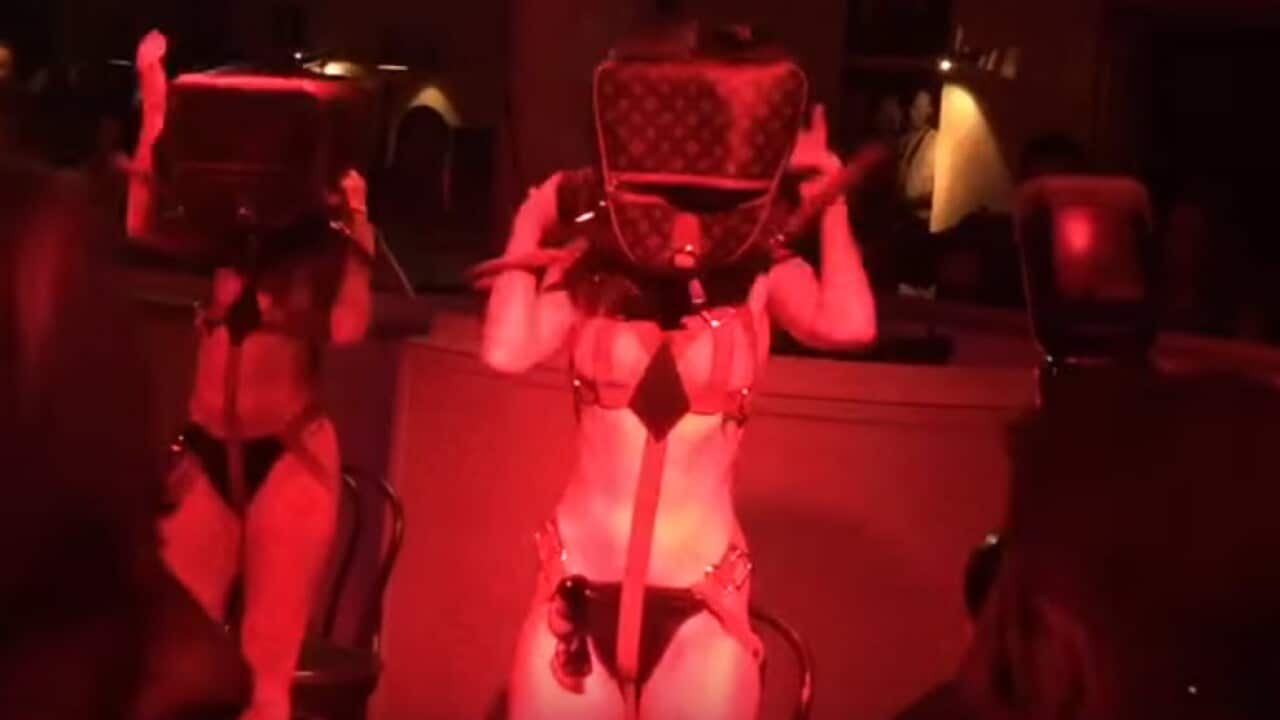 Classy. Scantily clad women dance with Luis Vuitton bags on the head at a M&C Saatchi 21st anniversary. (YouTube)
