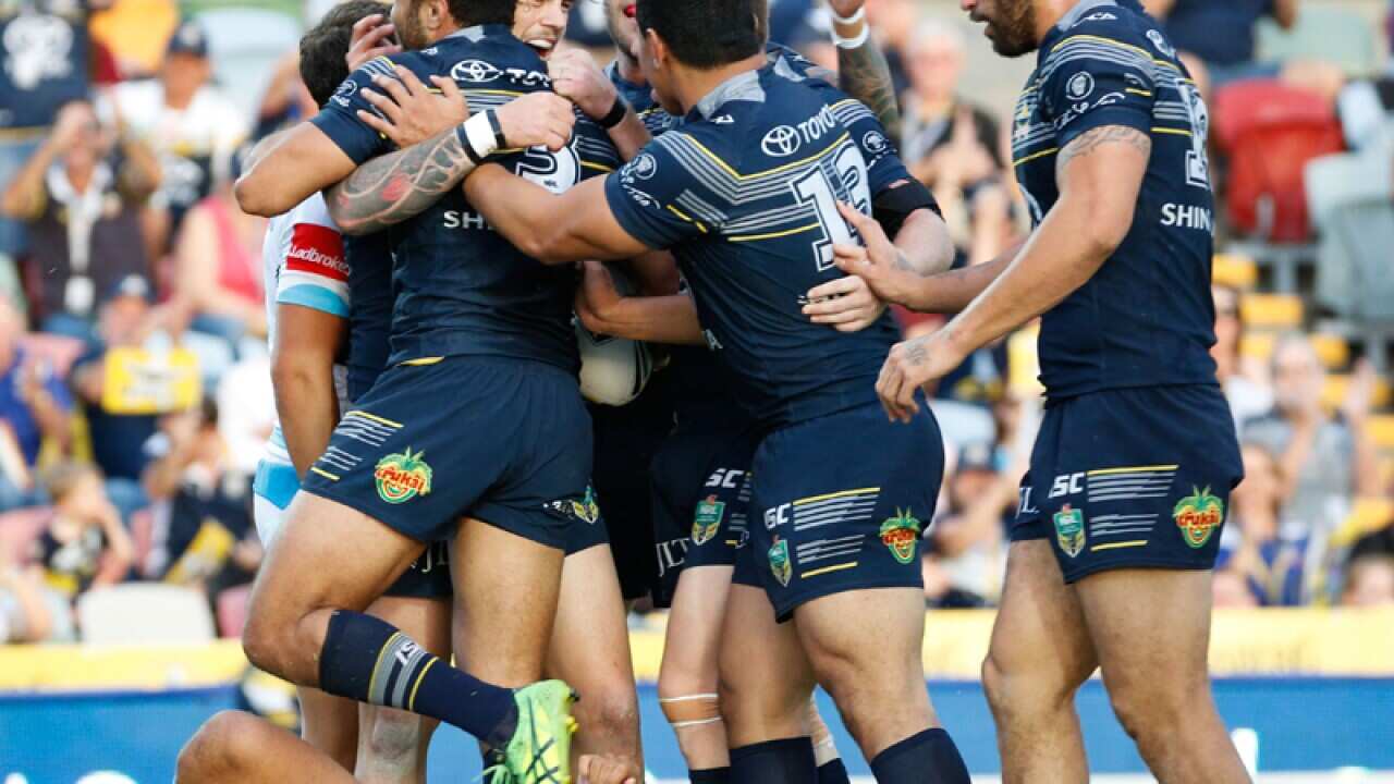 Justin O'Neill of the Cowboys is congratulated by team mates