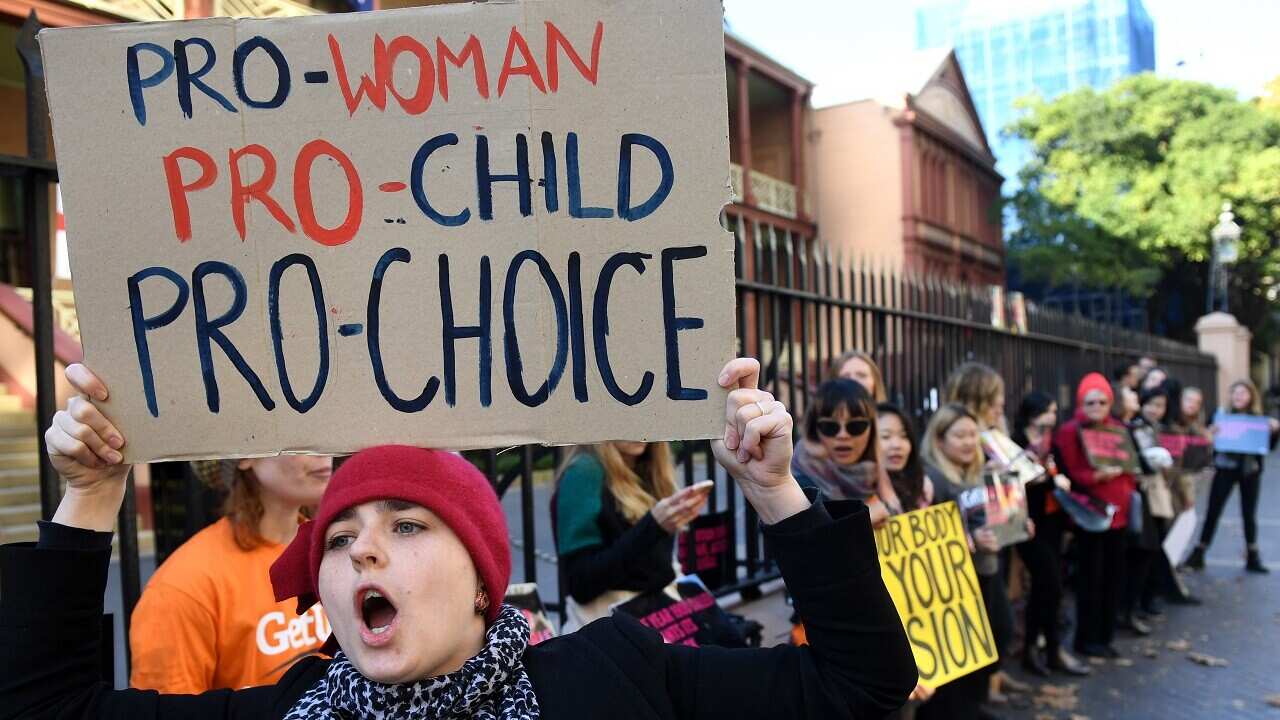 Protesters gather outside of the NSW State Parliament urging MPs to decriminalise abortion.