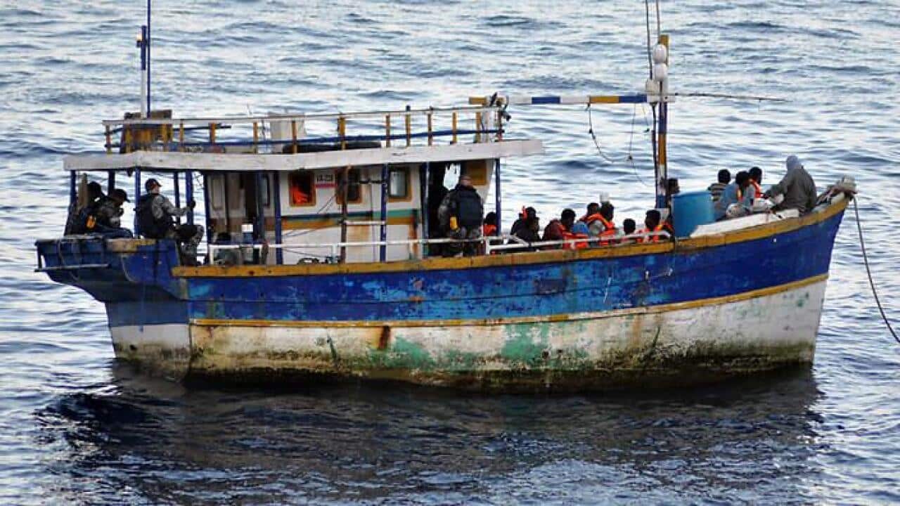 An asylum seeker's boat in the sea - SBS