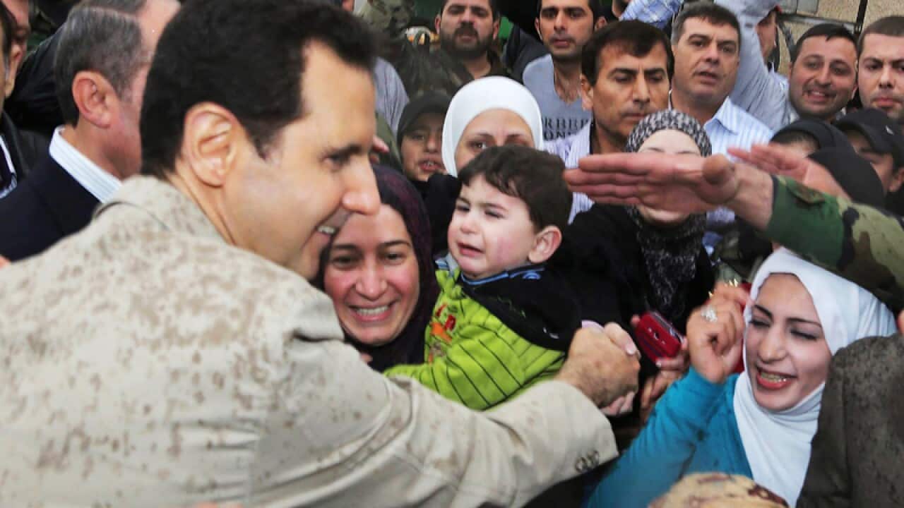 Syrian president Bashar Assad greets supporters.