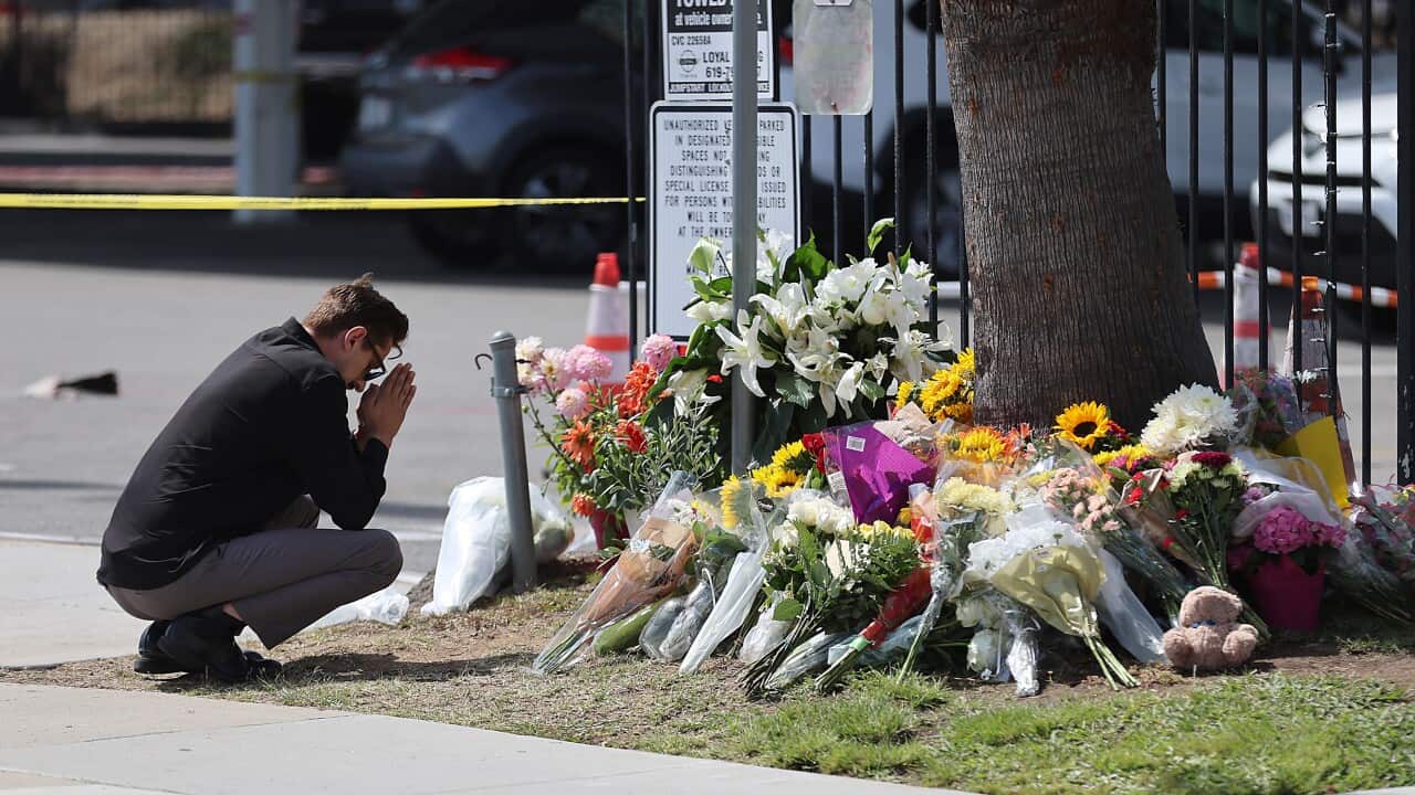 People mourn following the deadly shooting at San Diego Islamic Center