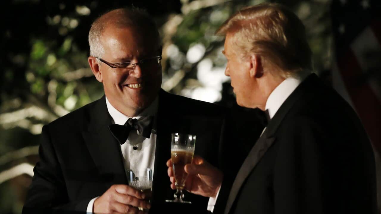 President Donald Trump and Prime Minister Scott Morrison toast as they speak in the Rose Garden outside the White House.
