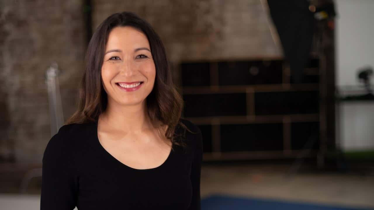 SBS Insight host, Kumi Taguchi, looking directly at camera and smiling.