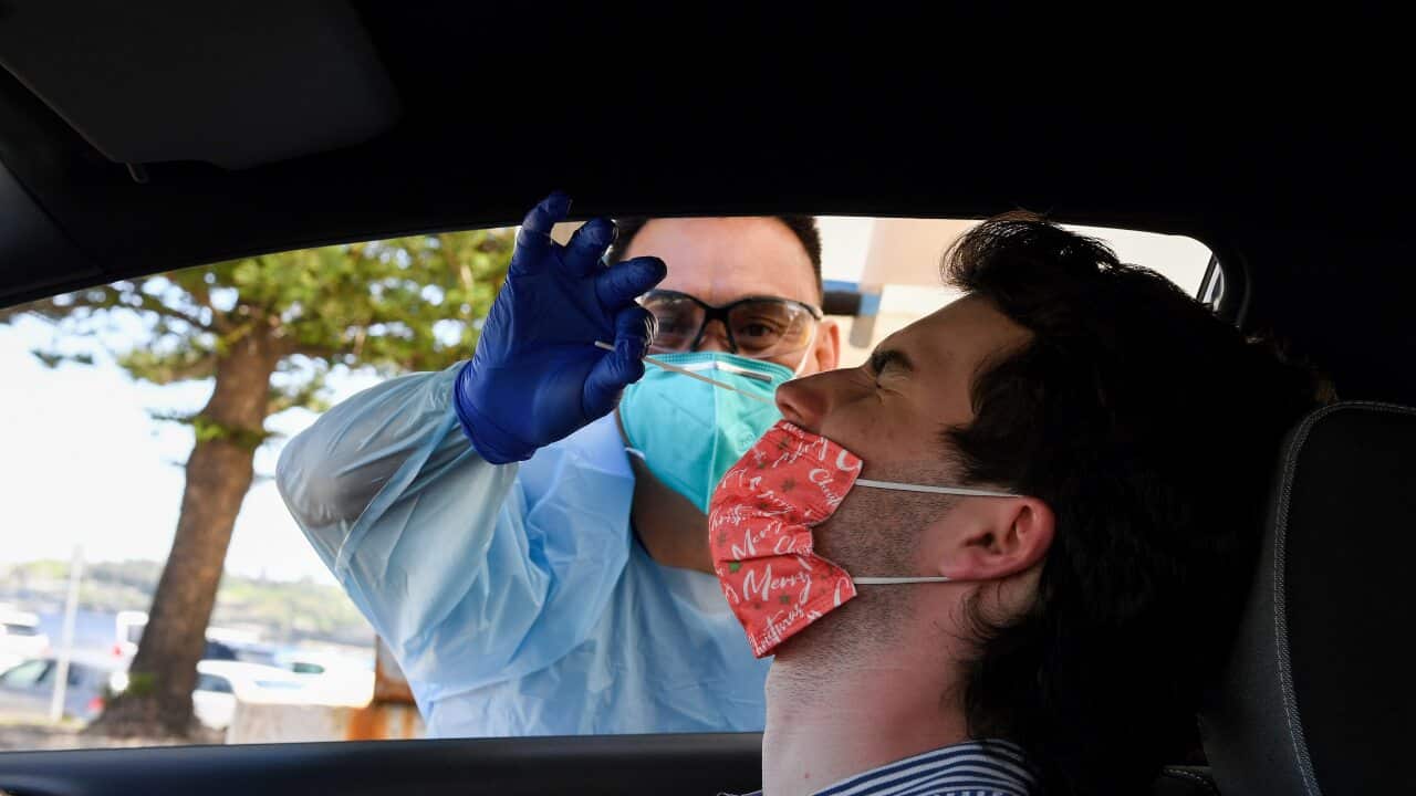 Angus Horton receives a COVID-19 test at the St Vincents Hospital drive-through testing clinic at Bondi Beach in Sydney, Wednesday, December 15, 2021. NSW will open up to the unvaccinated just as COVID-19 cases start to spiral, and the highly transmissibl