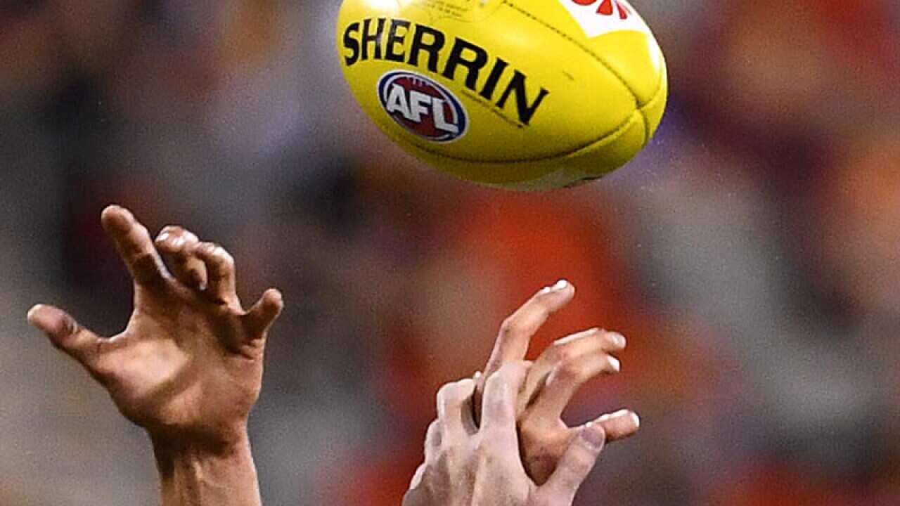 AFL players competing for the ball