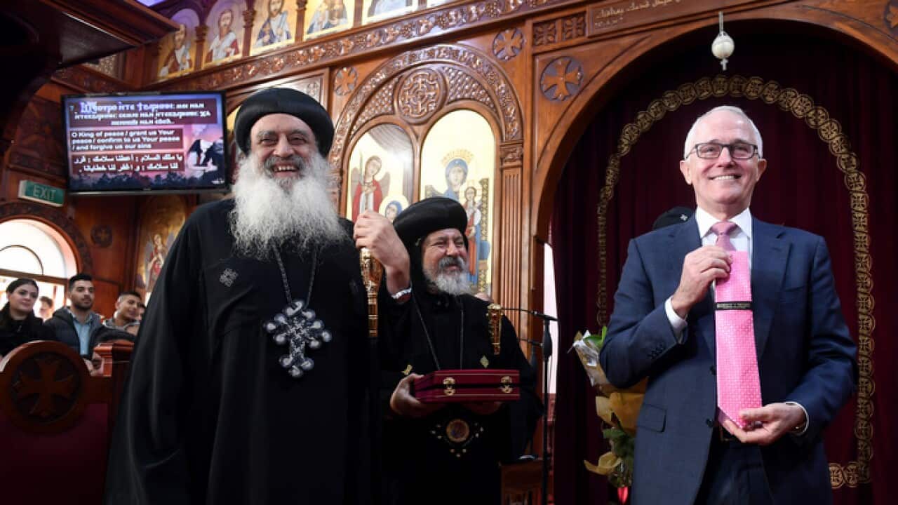 Prime Minister Malcolm Turnbull displays a tie given to him