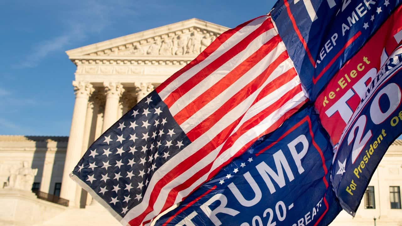 A supporter of Donald Trump holds a flag outside the Supreme Court in Washington, DC, USA, 11 December 2020