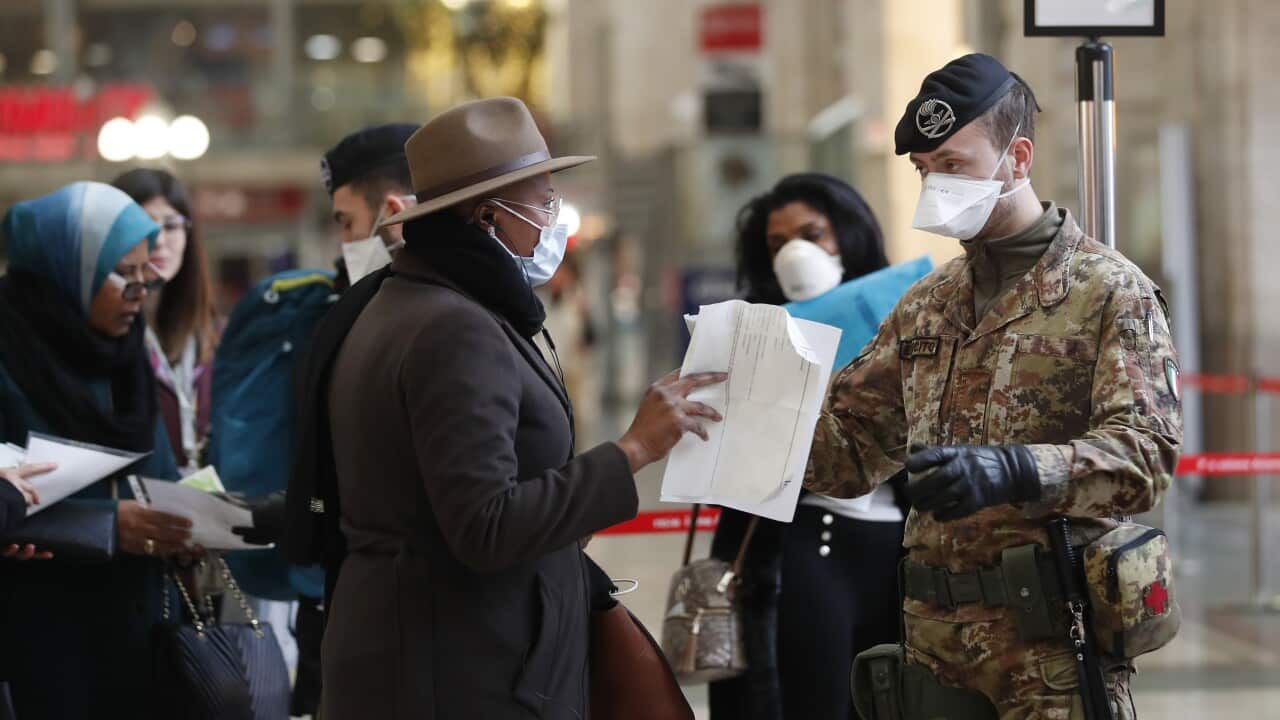 Police officers and soldiers check passengers leaving from Milan main train station, Italy, Monday, 9 March, 2020.