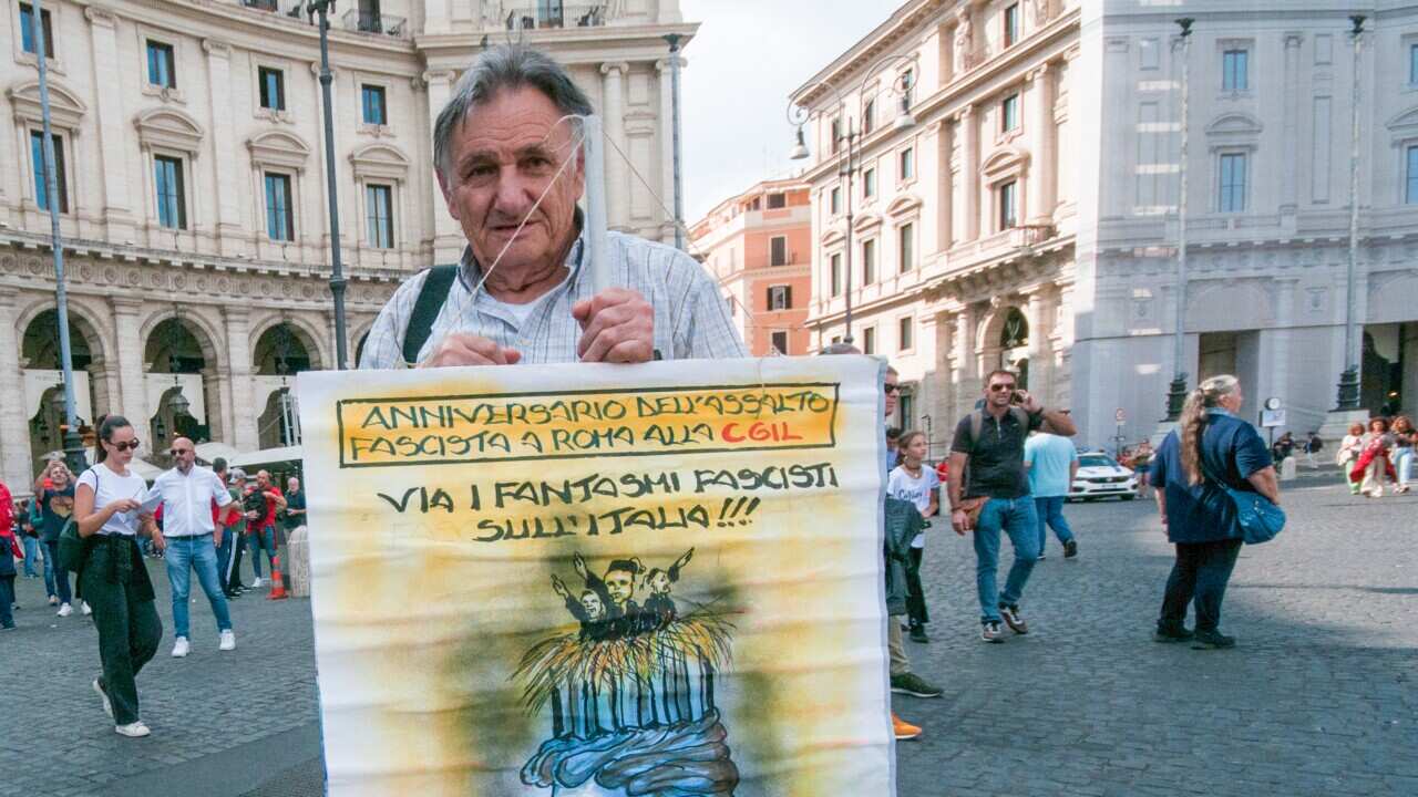 A protester at the CGIL demonstration with an antifascist placard